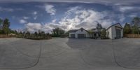 a fisheye image shows the driveway outside of the home and side of the garage