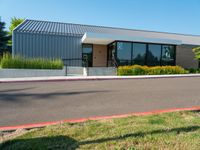 a metal building has windows on each side and windows at the other side of it