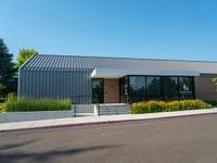 a metal building has windows on each side and windows at the other side of it