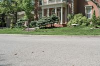 residential street with houses on one corner and trees to the other side of a road