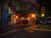 a small restaurant on a quiet street at night with no lights in it and signs warning drivers