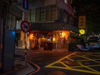 a small restaurant on a quiet street at night with no lights in it and signs warning drivers