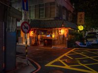 a small restaurant on a quiet street at night with no lights in it and signs warning drivers