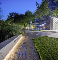 the name of the office sits in front of a city sidewalk, lit up by illuminated lights