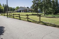 the rural landscape is seen along the driveway in front of the home and surrounding grounds