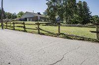 the rural landscape is seen along the driveway in front of the home and surrounding grounds