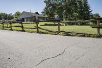 the rural landscape is seen along the driveway in front of the home and surrounding grounds