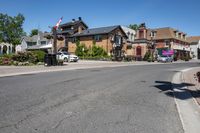 a road is surrounded by a very big house with a canadian flag flying high above it