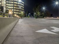 a view of a road and an overpass with traffic passing through it by buildings