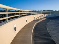 this is an image of a wall and walkway near a water treatment station and a lake