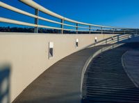 this is an image of a wall and walkway near a water treatment station and a lake