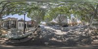 the reflection of trees on a suburban street in a mirror is seen here in this 360 - frame