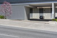 parked cars and cars parked in front of a garage with roller shutters over it