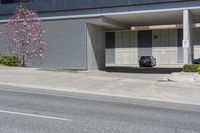 parked cars and cars parked in front of a garage with roller shutters over it