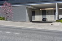 parked cars and cars parked in front of a garage with roller shutters over it