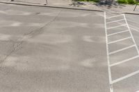 the man walks across the white lines of a parking lot for his vehicle to drive