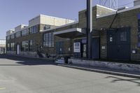 a person on a skateboard in front of a school with an awning over it