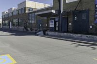 a person on a skateboard in front of a school with an awning over it