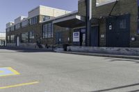 a person on a skateboard in front of a school with an awning over it