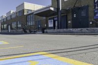 a person on a skateboard in front of a school with an awning over it