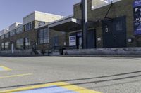 a person on a skateboard in front of a school with an awning over it