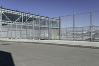 the fenced area has metal bars to keep people from entering the building's entrance