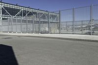 the fenced area has metal bars to keep people from entering the building's entrance