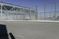 the fenced area has metal bars to keep people from entering the building's entrance