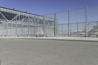 the fenced area has metal bars to keep people from entering the building's entrance