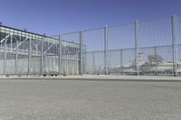 the fenced area has metal bars to keep people from entering the building's entrance