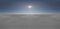 the sun shines over a vast open desert area with thin lines made of ropes