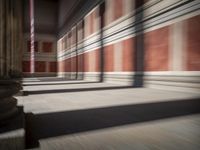 columns are lined up in a building that looks like it was built from wood and brick