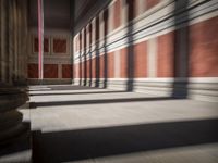 columns are lined up in a building that looks like it was built from wood and brick