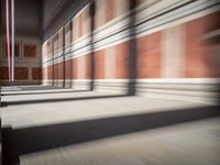 columns are lined up in a building that looks like it was built from wood and brick