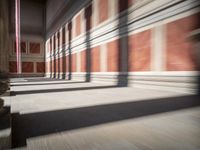 columns are lined up in a building that looks like it was built from wood and brick
