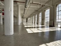 sunlight shines through large windows in a building that overlooks a city outside on its sides