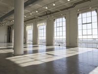 sunlight shines through large windows in a building that overlooks a city outside on its sides