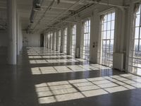 sunlight shines through large windows in a building that overlooks a city outside on its sides