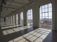 sunlight shines through large windows in a building that overlooks a city outside on its sides