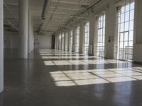 sunlight shines through large windows in a building that overlooks a city outside on its sides