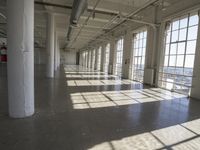 sunlight shines through large windows in a building that overlooks a city outside on its sides