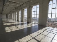 sunlight shines through large windows in a building that overlooks a city outside on its sides