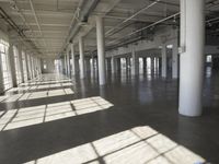 sunlight shines through large windows in a building that overlooks a city outside on its sides