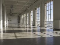 sunlight shines through large windows in a building that overlooks a city outside on its sides