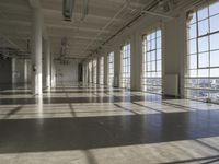 sunlight shines through large windows in a building that overlooks a city outside on its sides