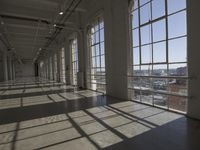 sunlight shines through large windows in a building that overlooks a city outside on its sides