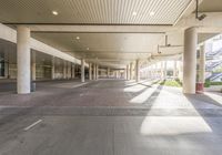 an empty parking garage is seen in this image in sunlight time a bus is parked at the back