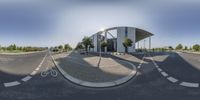 a 360 - view photograph of a parking lot in the sun, looking down at it