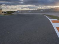 Sunlit Race Track Valencia Straight Road with Dramatic Mountains