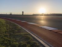 Sunlit Sea Line: Asphalt Road Bathed in Sunlight